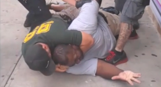 Four NYPD officers kill Eric Garner on video.