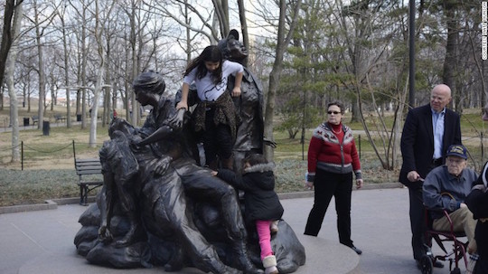 Children climb on the Vietnam War women's memorial in Washington, DC.