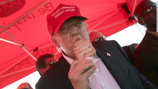 A big, pink, under-grilled slab of meat eats a pork chop at the fairgrounds.
