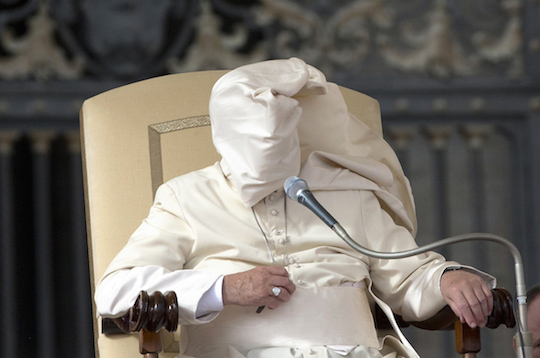 Wind blows the Pope's mantle over his face in this photo by Alessandra Tarantino (AP).
